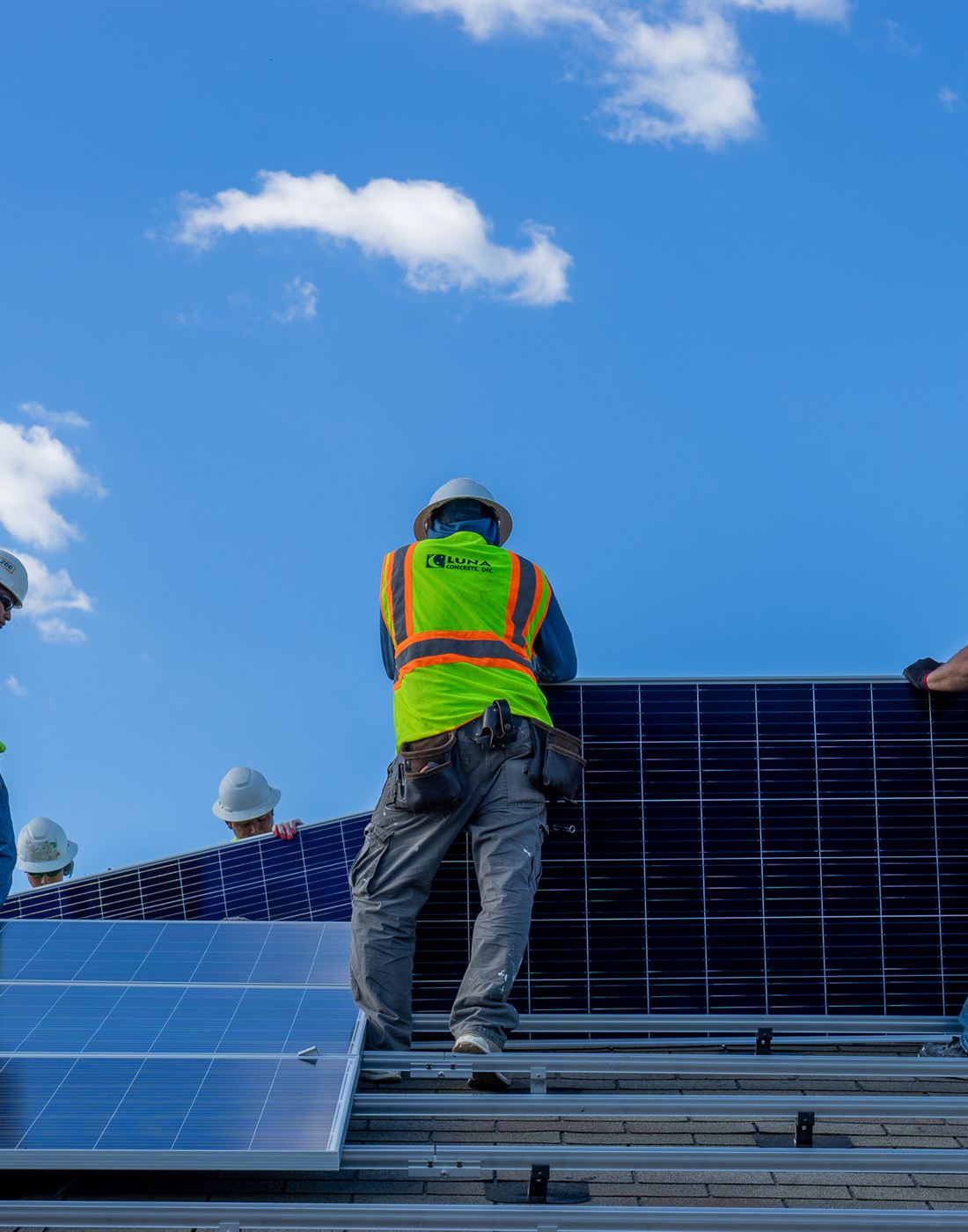 Azimuth 180 technicians carrying a solar module on site