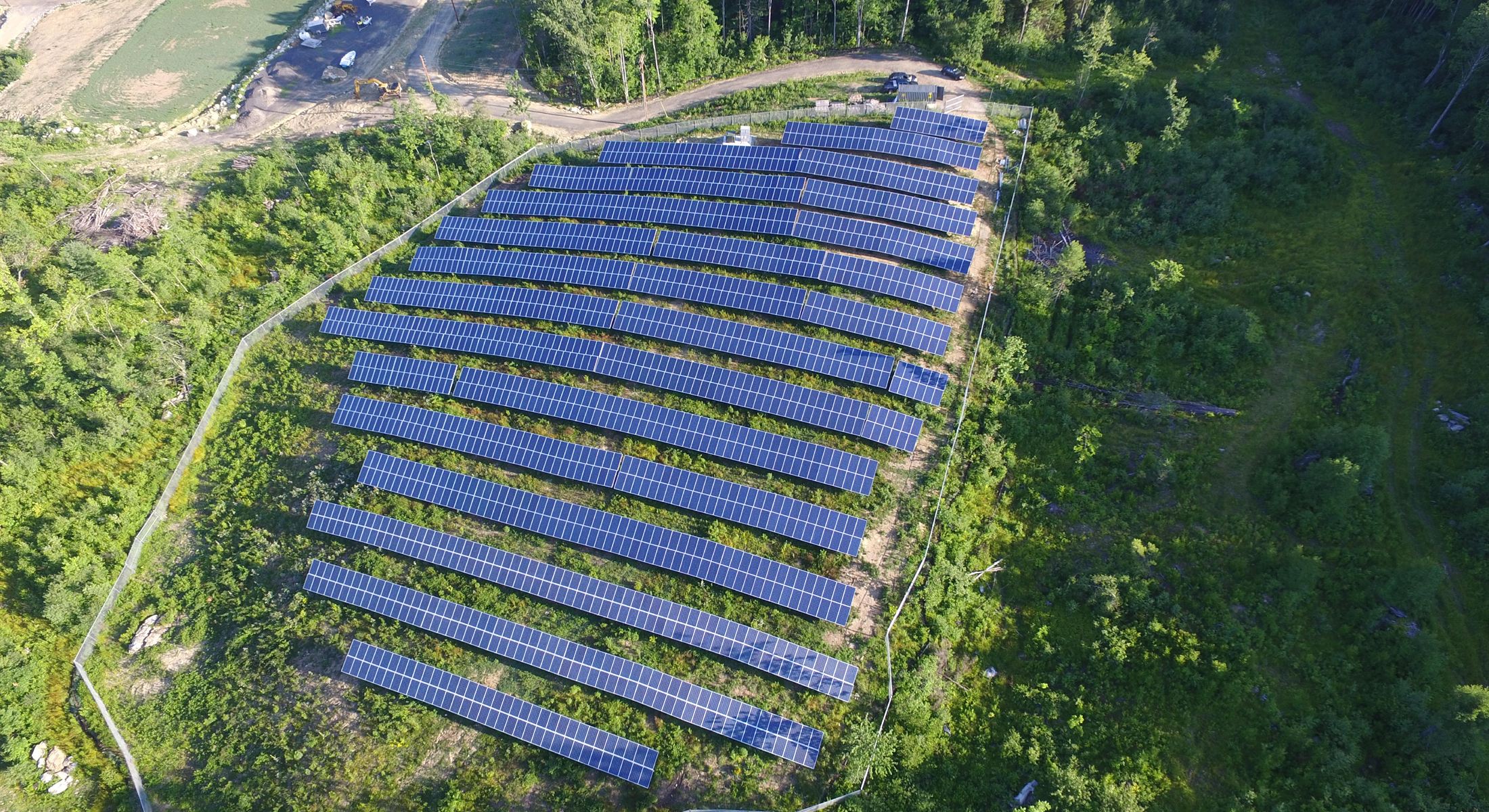 Aerial view of the Westminster ground-mount solar array surrounded by green hills